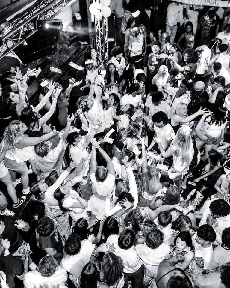 A packed dance floor at CTRL seen from above, with hands raised toward the lighting truss during a Saturday night in downtown Springfield, Missouri.